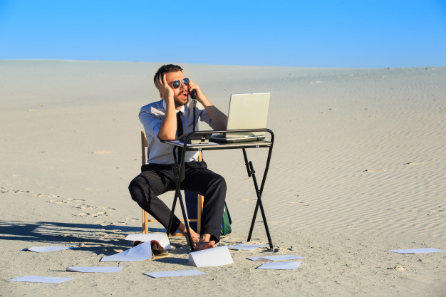 businessman-using-laptop-desert_155003-2401